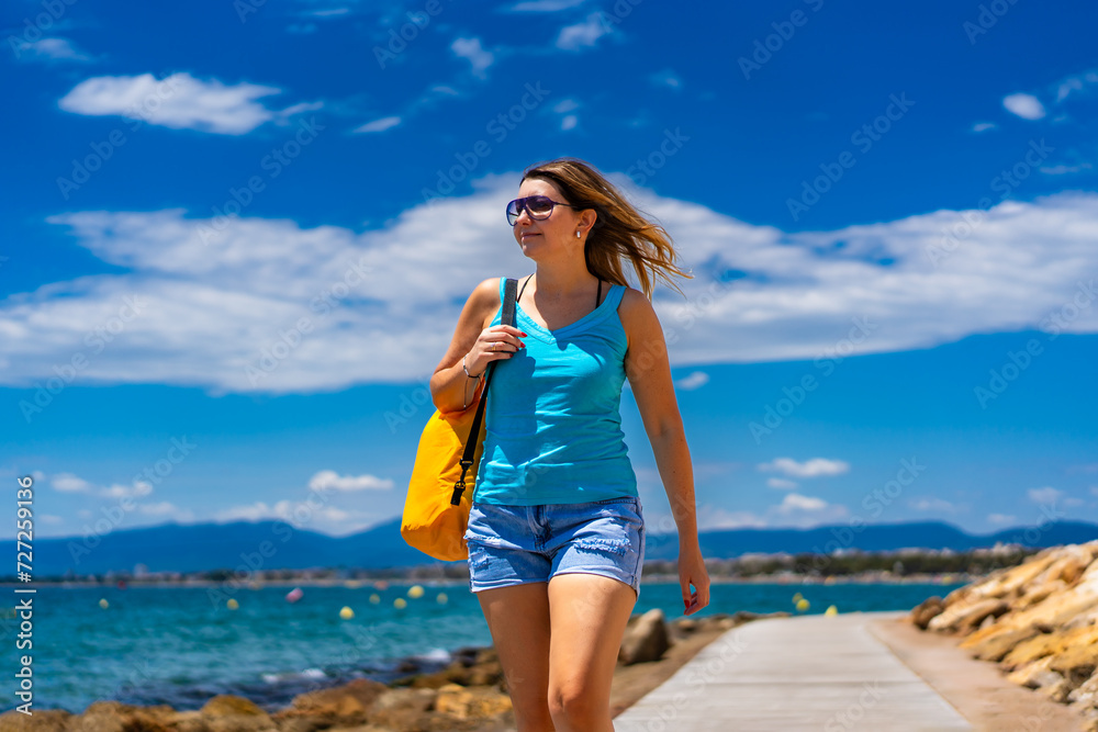 Beautiful woman walking on seaside boulevard - Costa Dorada Spain
Beautiful woman walking on seaside boulevard - Costa Dorada Spain