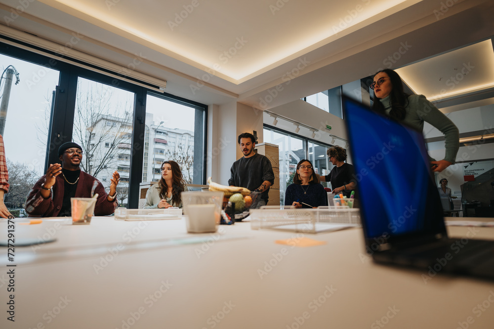 A dynamic business team in a casual meeting in a contemporary office space, actively engaging in discussion with focus and enthusiasm. A dynamic business team in a casual meeting in a contemporary office space, actively engaging in discussion with focus and enthusiasm.