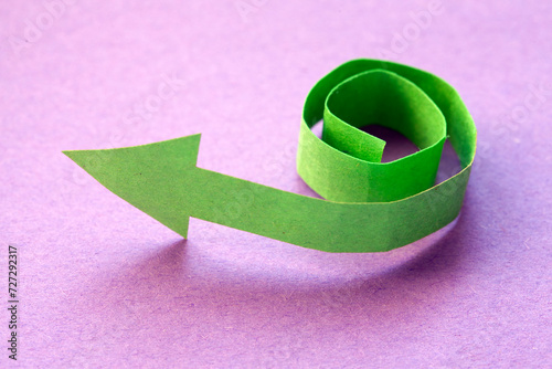 spiralled turn, green paper arrow photo