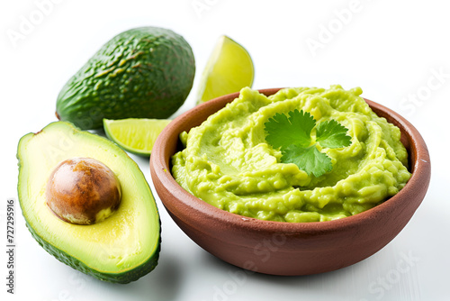 Guacamole isolated on white. Fresh avocado dip garnished with cilantro on white. Traditional Mexican guacamole, ripe avocados on side. Cinqo de Mayo food