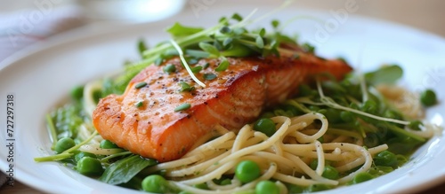 Salmon, watercress, and green peas served with linguine pasta.