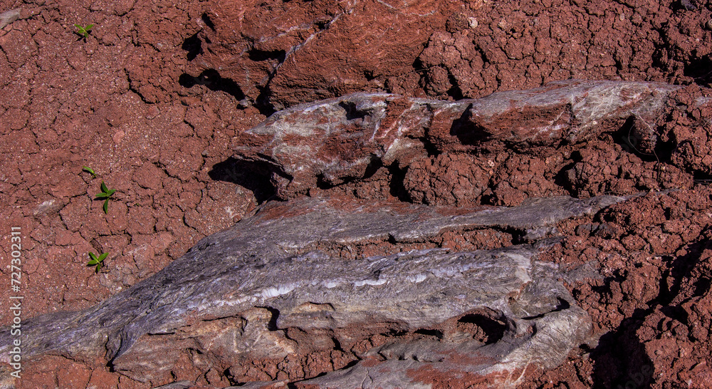 Fototapeta premium Red stones, blue sky, green water