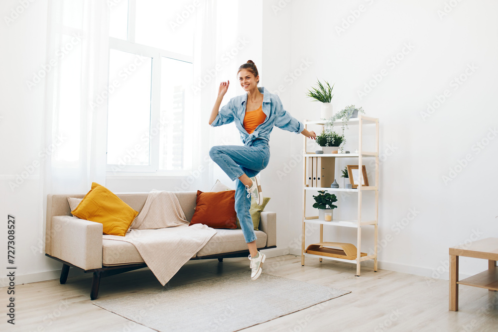 Joyful Woman Jumping and Dancing in a Playful Indoor Concept: Relaxation and Carefree Happiness Joyful Woman Jumping and Dancing in a Playful Indoor Concept: Relaxation and Carefree Happiness