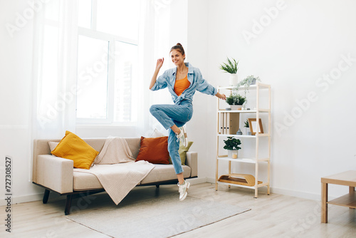 Joyful Woman Jumping and Dancing in a Playful Indoor Concept: Relaxation and Carefree Happiness
