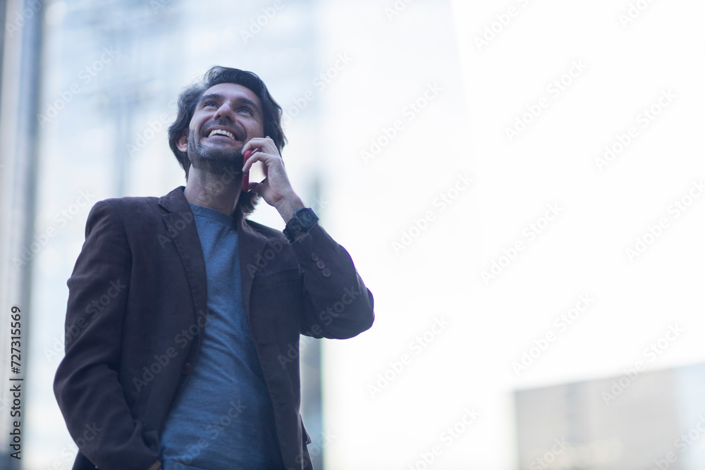 View of young man using a smartphone at twilight View of young man using a smartphone at twilight