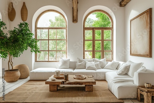 a bright and airy living room with high arched windows, white walls and furniture