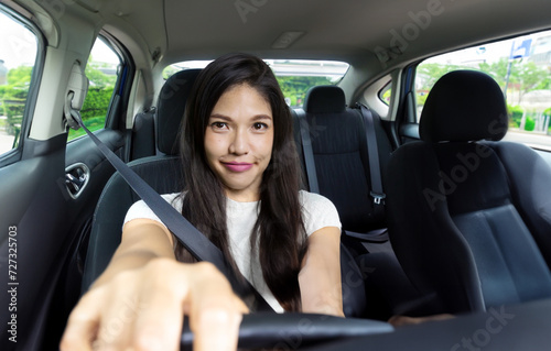 Asian woman is confident in driving her own car to provide passenger and cargo transport services