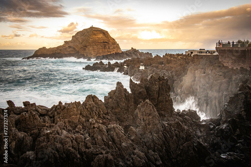sunset, waves crashing on natural lava swimming pools of porto moniz, madeira, atlantic ocean, portugal, europe, storm, waves, lava