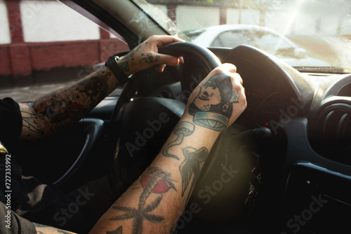Car Interior with Tattooed Man Behind the Wheel