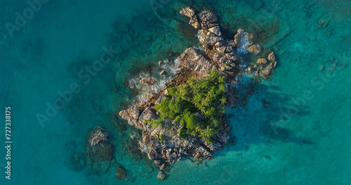 Tropical island with sea and palm taken from drone. Seychelles aerial photo. St Pierre Island