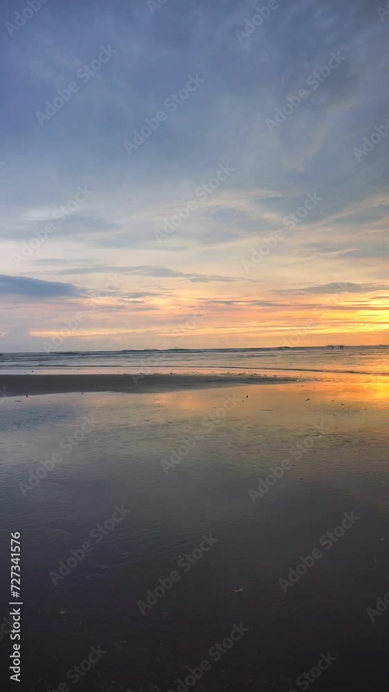 vertical video of beautiful views of the sunset on the beach with small waves, natural panoramas in the afternoon on Cipatujah Tasikmalaya beach vertical video of beautiful views of the sunset on the beach with small waves, natural panoramas in the afternoon on Cipatujah Tasikmalaya beach