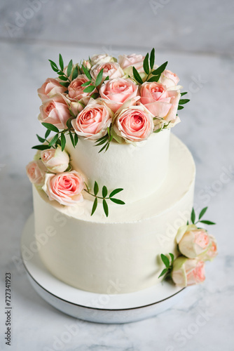Delicate wedding bunk cake decorated with roses. White cake to order for a holiday. © Виктор Мошко