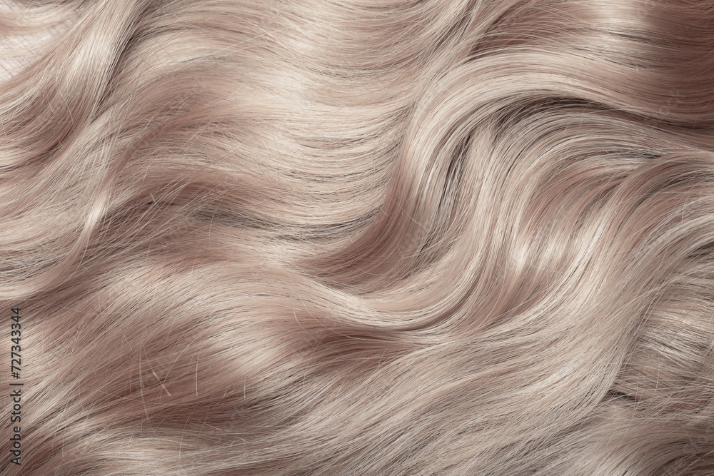 Blond hair close-up as a background. Women's long light brown hair. Beautifully styled wavy shiny curls. Hair coloring. Hairdressing procedures, extension. Blond hair close-up as a background. Women's long light brown hair. Beautifully styled wavy shiny curls. Hair coloring. Hairdressing procedures, extension.