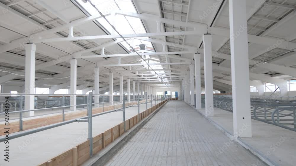 The construction of the new barn. An empty barn. Modern new cattle farm.
The construction of the new barn. An empty barn. Modern new cattle farm.