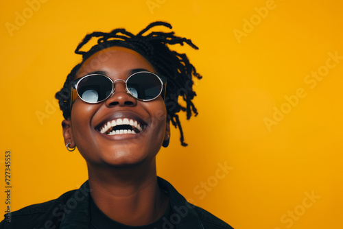 happy smiling young black woman with afro hair. Spring portrait of excited young woman. Happy African woman in glasses looking at camera, smiling.