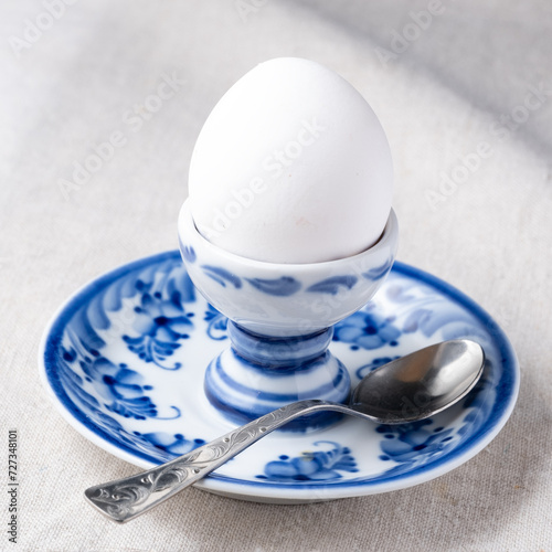 white boiled egg on plate with metal tea-spoon