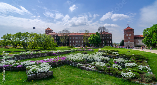 Summer view of Wawel Royal Castle complex in Krakow, Poland. It is the most historically and culturally important site in Poland. Flowers on a foreground
