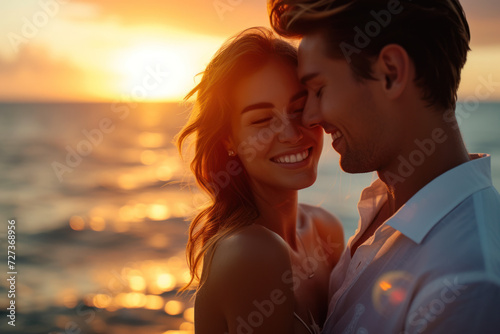 a young happy couple on the seashore, basked in the warm and golden light of the sunset