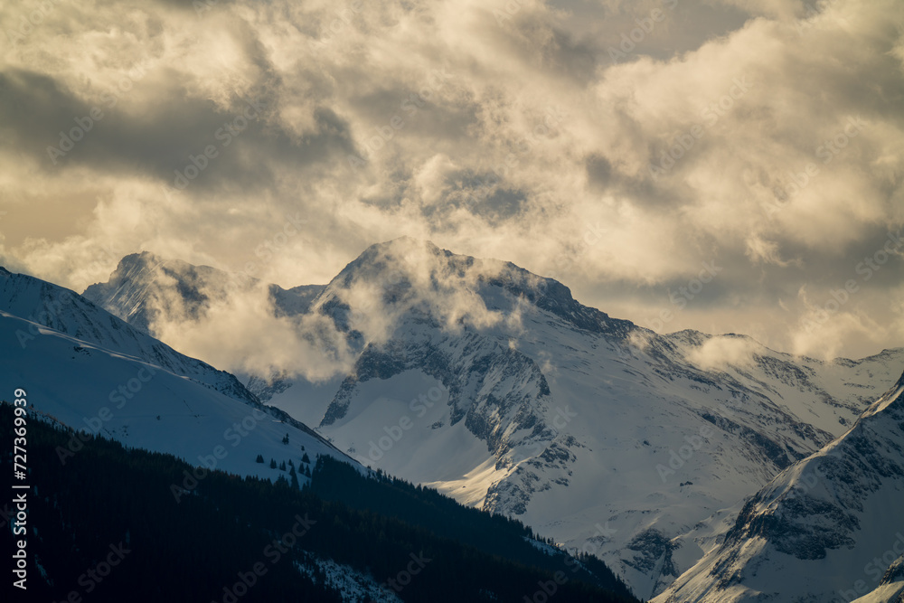 beautiful view of the alps, the hohe tauern in the national park austria, at a cloudy and sunny winter morning