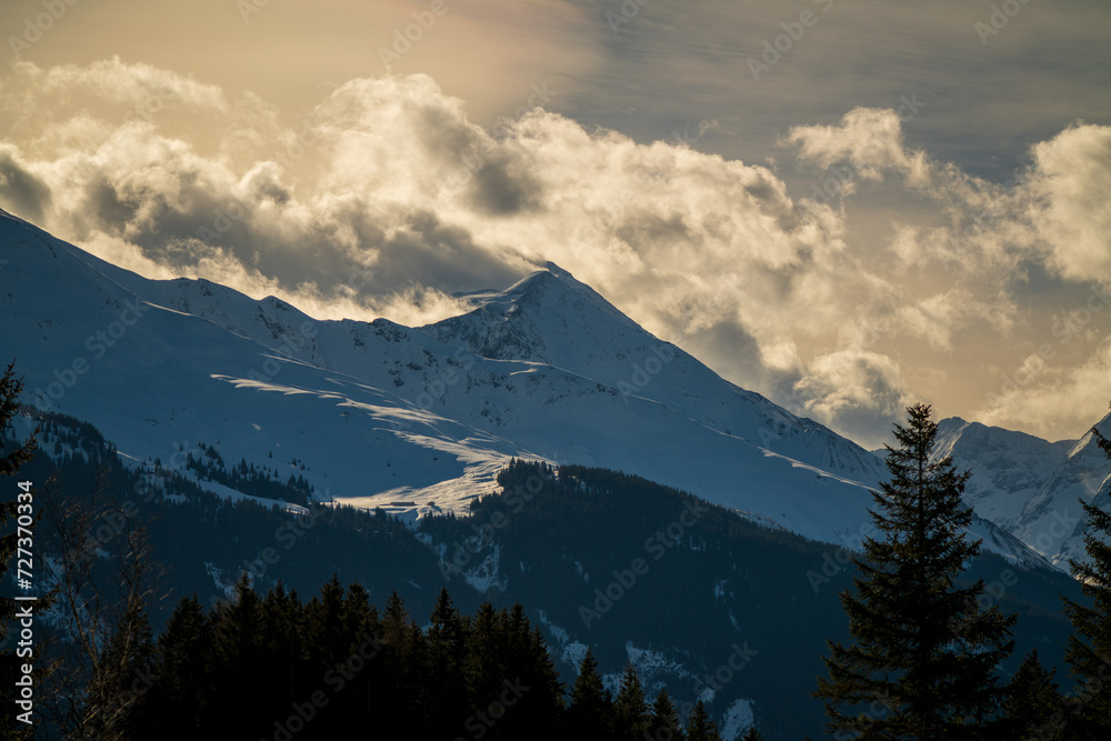 beautiful view of the alps, the hohe tauern in the national park austria, at a cloudy and sunny winter morning