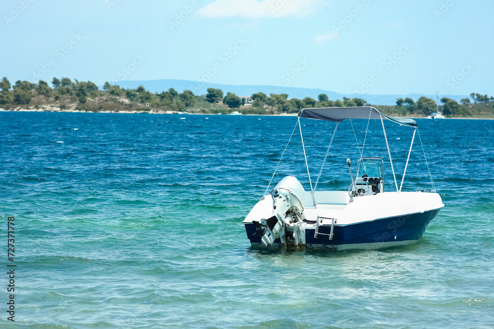 Fototapeta premium A beautiful boat floating on the background of the sea silhouette