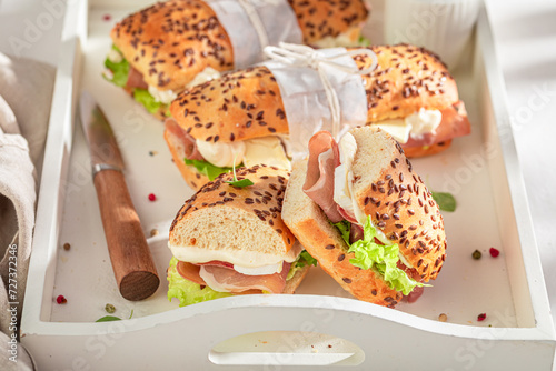 Healthy sandwich with prosciutto, camembert and lettuce.