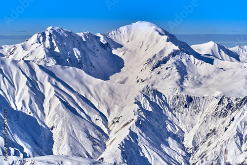 Breathtaking beautiful panoramic view on Snow Alps - snow-capped winter mountain peaks around French Alps mountains, The Three Valleys: Courchevel, Val Thorens, Meribel (Les Trois Vallees), France © udmurd