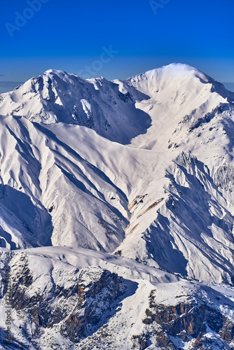 Breathtaking beautiful panoramic view on Snow Alps - snow-capped winter mountain peaks around French Alps mountains, The Three Valleys: Courchevel, Val Thorens, Meribel (Les Trois Vallees), France photo