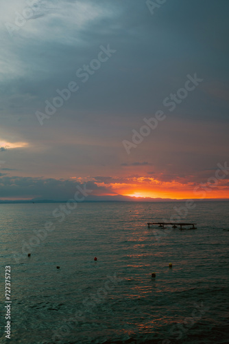 Obraz na płótnie Long exposure shot of a sunrise or sunset on a sea waterbody against dramatic clouds located in Drosia, Zakinthos, Greece w salonie