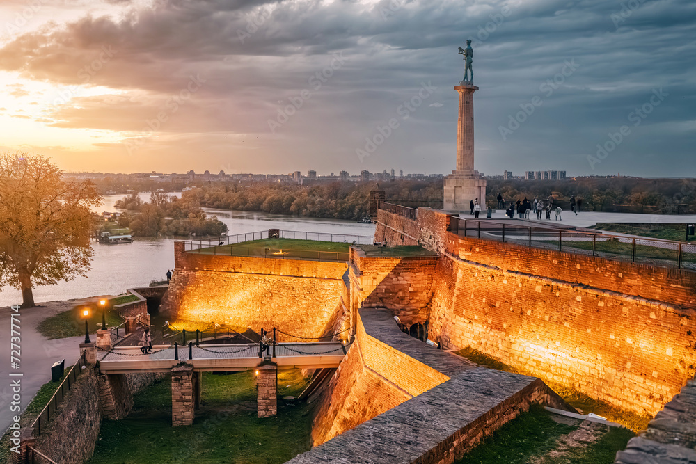As the sun sets, Belgrade's Kalemegdan fortress comes alive with illumination, a captivating sight for tourists and travelers.