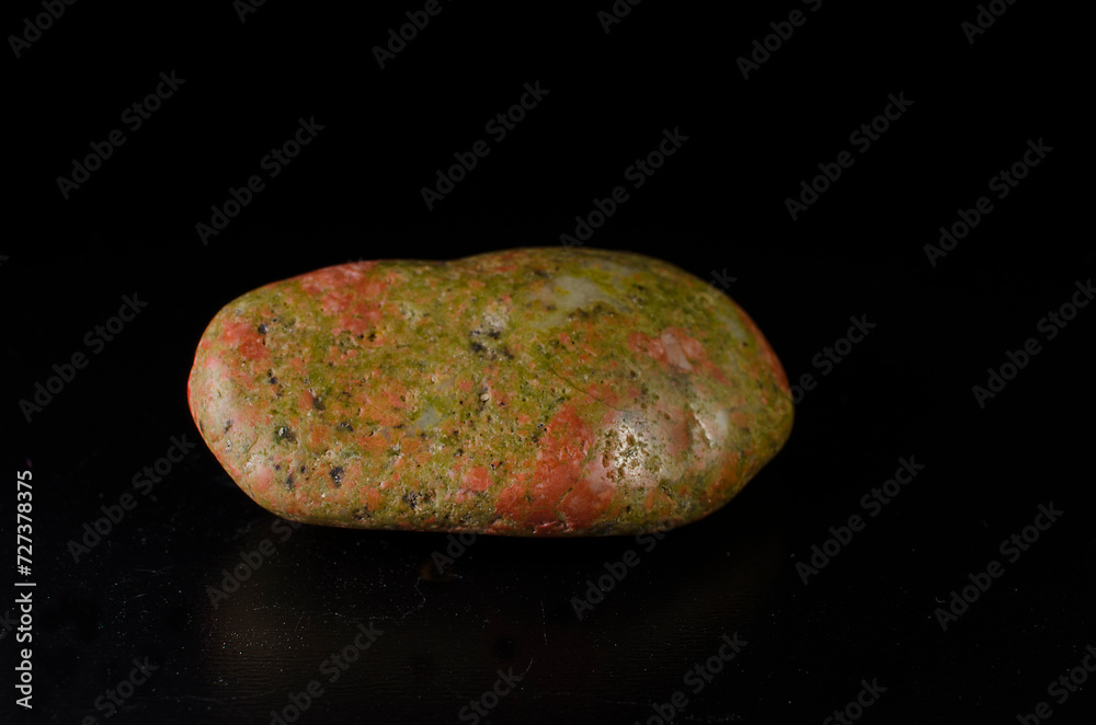 unakite mineral stone on black background