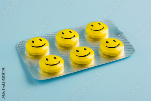 Blister with yellow smiling pills. Tablets, pharmacy, medicine, smile, emoji, vitamins, cheerful pills with drawn faces. Laughter is the best medicine, antidepressants concept