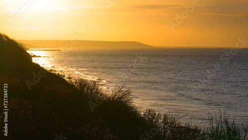 Sunset at the edge of the Normandy cliff against the light