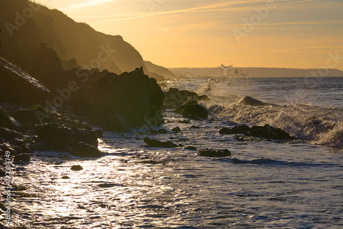 Sunset at the edge of the Normandy cliff against the light