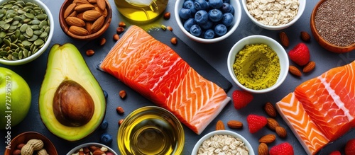 Bird's-eye image of nutritious omega-3 foods: Diverse options include fish, nuts, seeds, fruit, veggies, and oil.