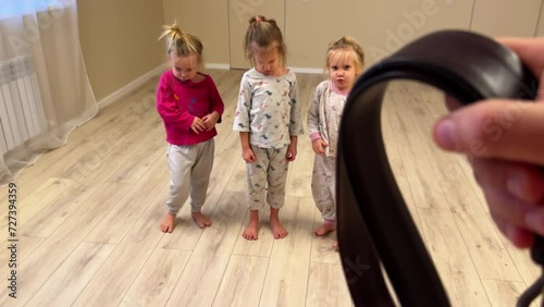 Three little girls, sisters, triplets, misbehaved and were afraid of punishment photo