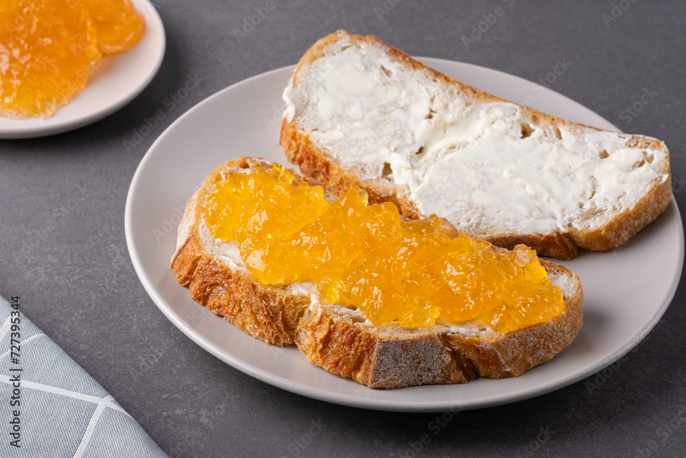 Sandwiches with apricot jam and butter on a gray background Sandwiches with apricot jam and butter on a gray background