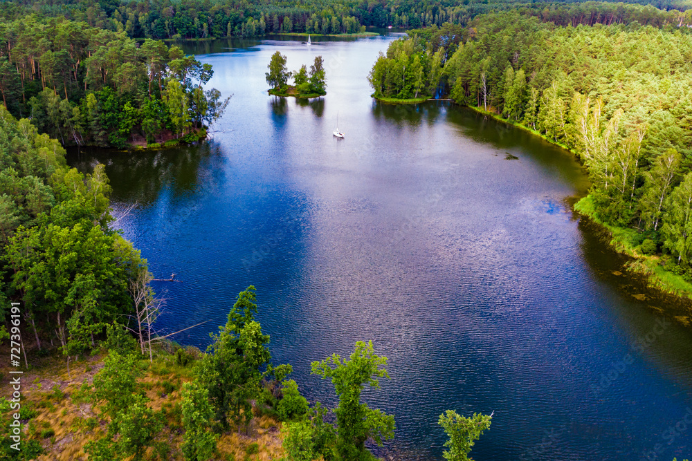 Aerial view yacht on lake in Tuchola Forests, Poland.