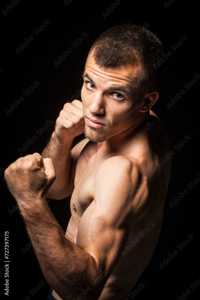 Portrait of young man in boxing pose