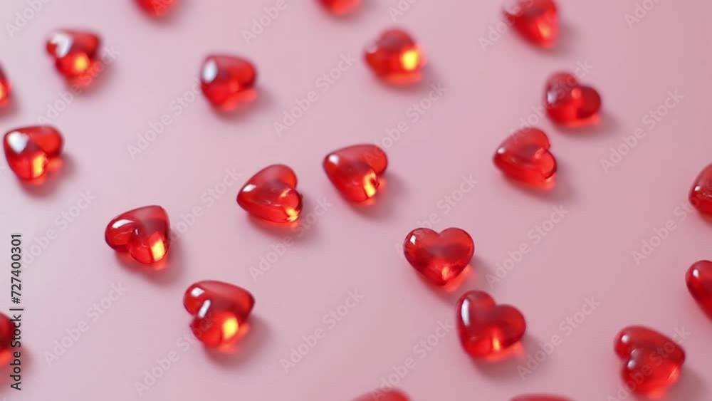 Many glass hearts on a pink background. Many glass hearts on a pink background.