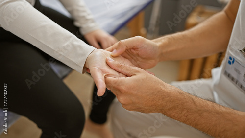 Wallpaper Mural Therapist man performs hand physiotherapy on female patient in a rehabilitation center. Torontodigital.ca