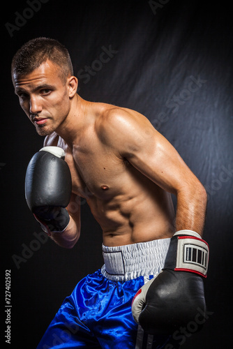 Portrait of a male boxer in guard. © JUAN
