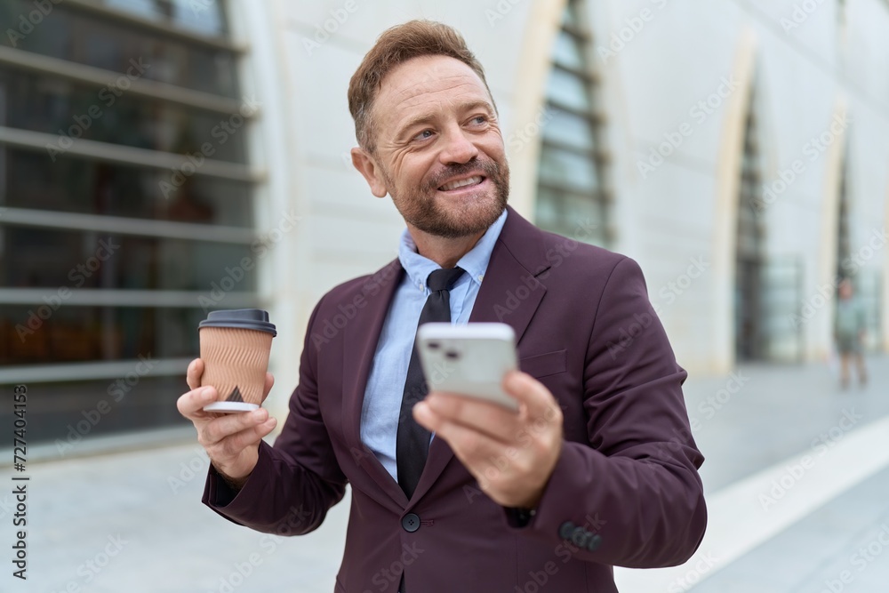 Middle age man business worker using smartphone drinking coffee at street Middle age man business worker using smartphone drinking coffee at street