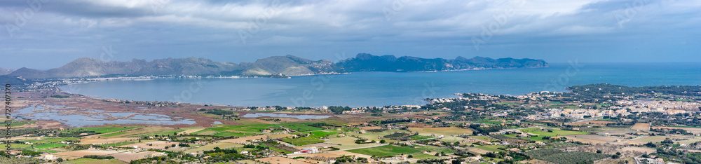 Panoramic View of Pollensa Bay in Mallorca with Coastal Towns and Mountain Backdrop