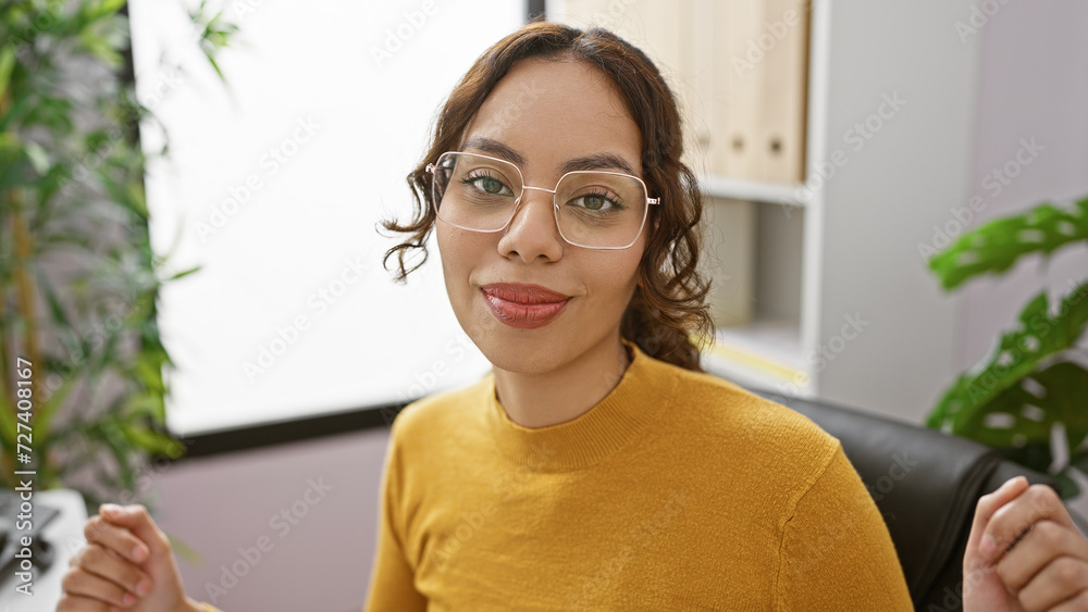 Confident young woman with glasses sitting in modern office, portrait of professional indoor. Confident young woman with glasses sitting in modern office, portrait of professional indoor.