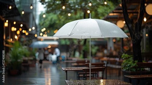 Wallpaper Mural a cafe during a rainy day through a high-quality, full-frame photo of a white umbrella, creating a compelling visual narrative of shelter and comfort amidst the rain. Torontodigital.ca