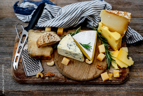 Cheese Plate With Nuts Placed On A Wooden Board Is A Delightful Snack