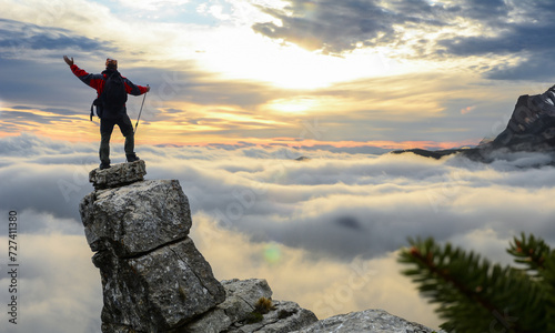 adventurer overlooking the foggy landscape of the cliff photo