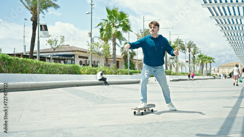 Young hispanic man using skate at park