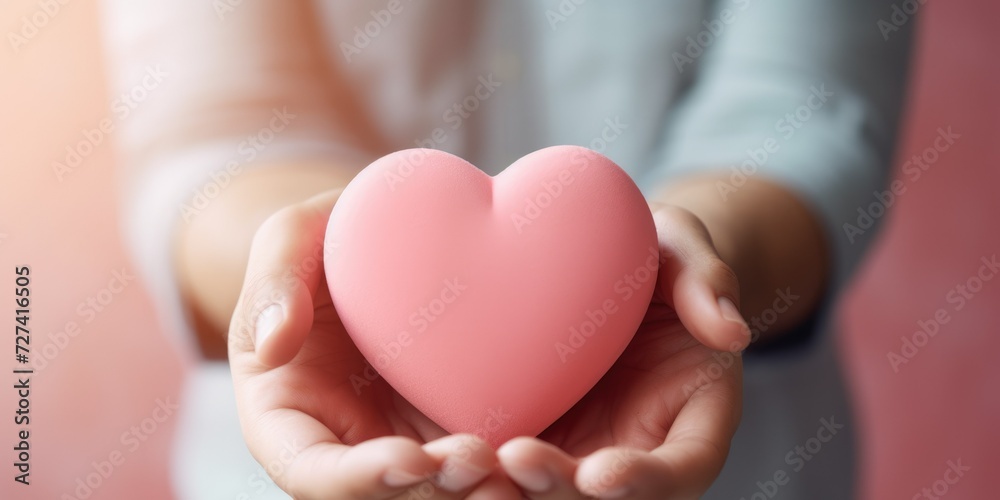woman holding a pink heart in her hands. Valentine's Day. Love. Feelings. Postcard. Mothers Day. Father's Day woman holding a pink heart in her hands. Valentine's Day. Love. Feelings. Postcard. Mothers Day. Father's Day